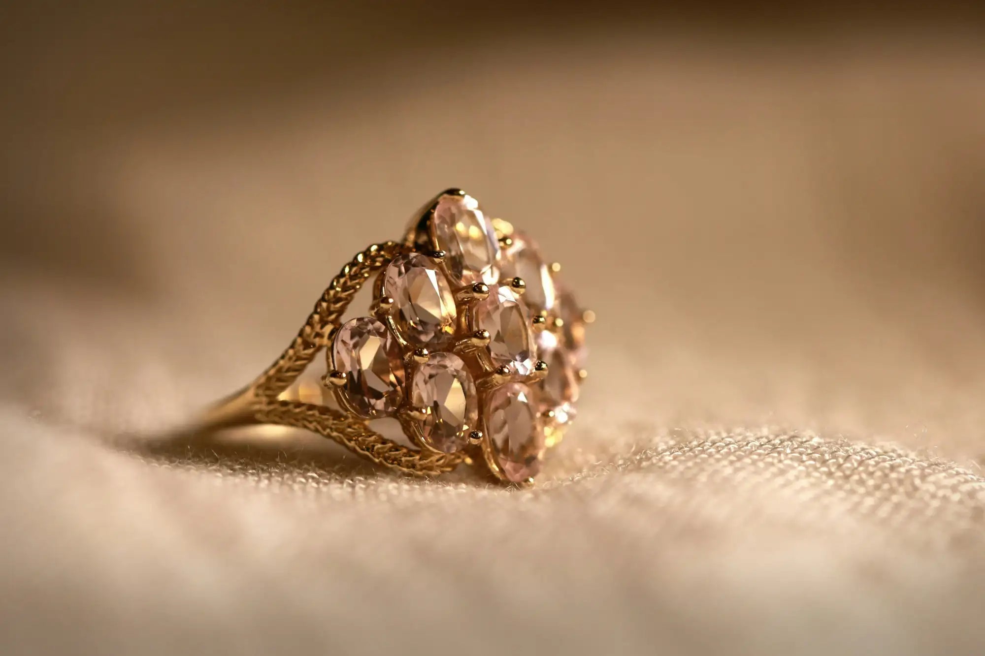 18k gold engagement ring with a marquise-cut diamond and intricate filigree detailing.